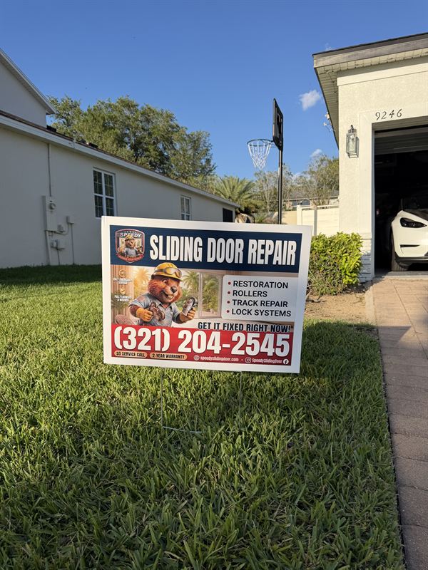 Speedy Sliding Door Repair yard sign planted on the front lawn of a real Central Florida customer home with palm tree and driveway visible