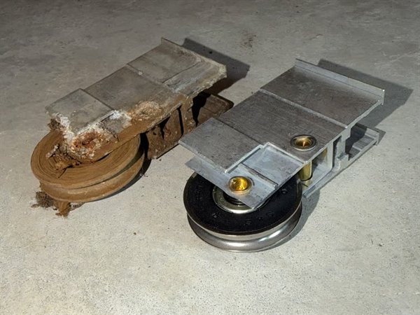 Worn sliding door roller next to a new replacement roller, close-up — Speedy Sliding Door Repair