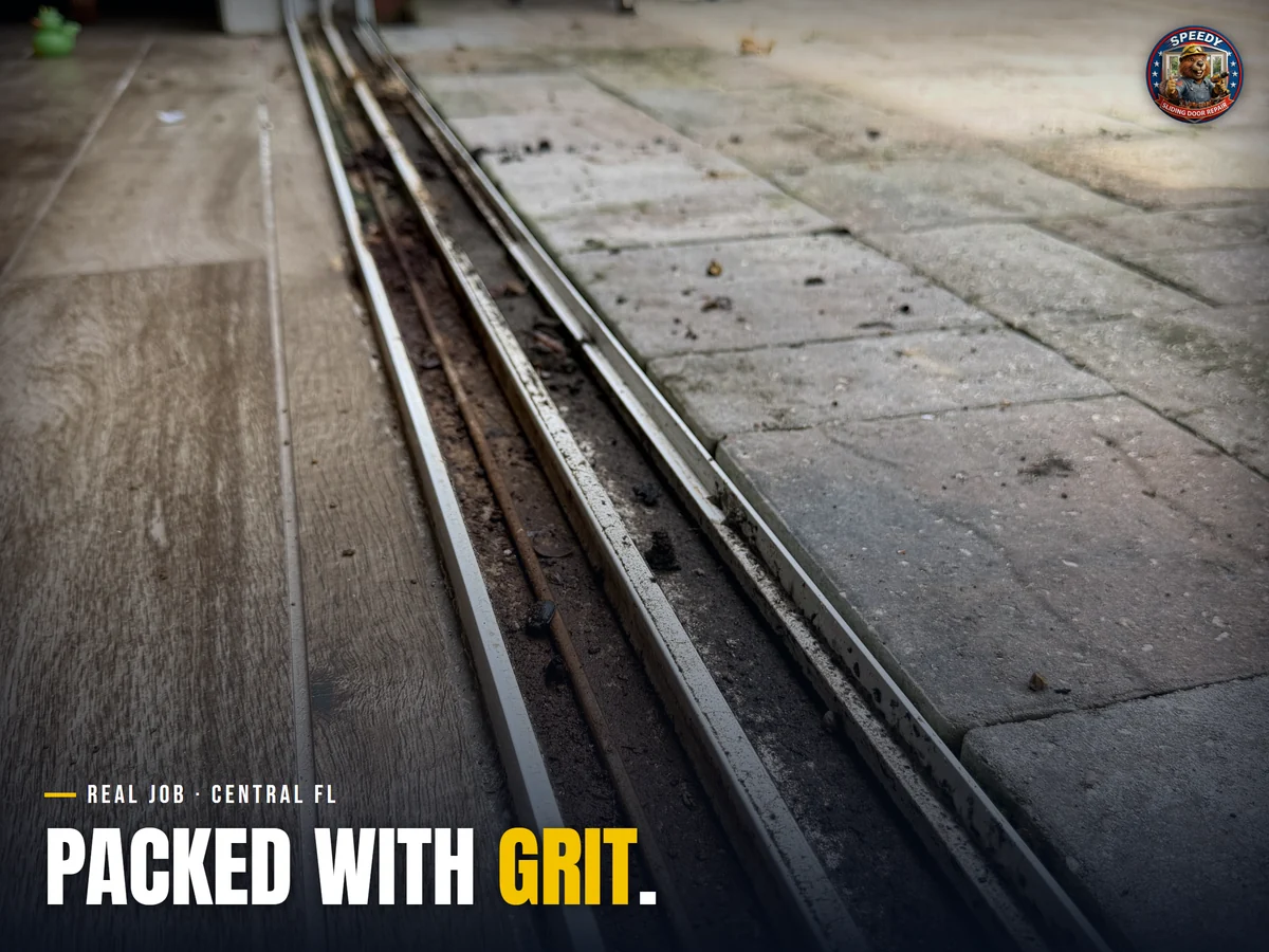 Sliding door bottom track packed with sand and grit before cleaning, Central Florida