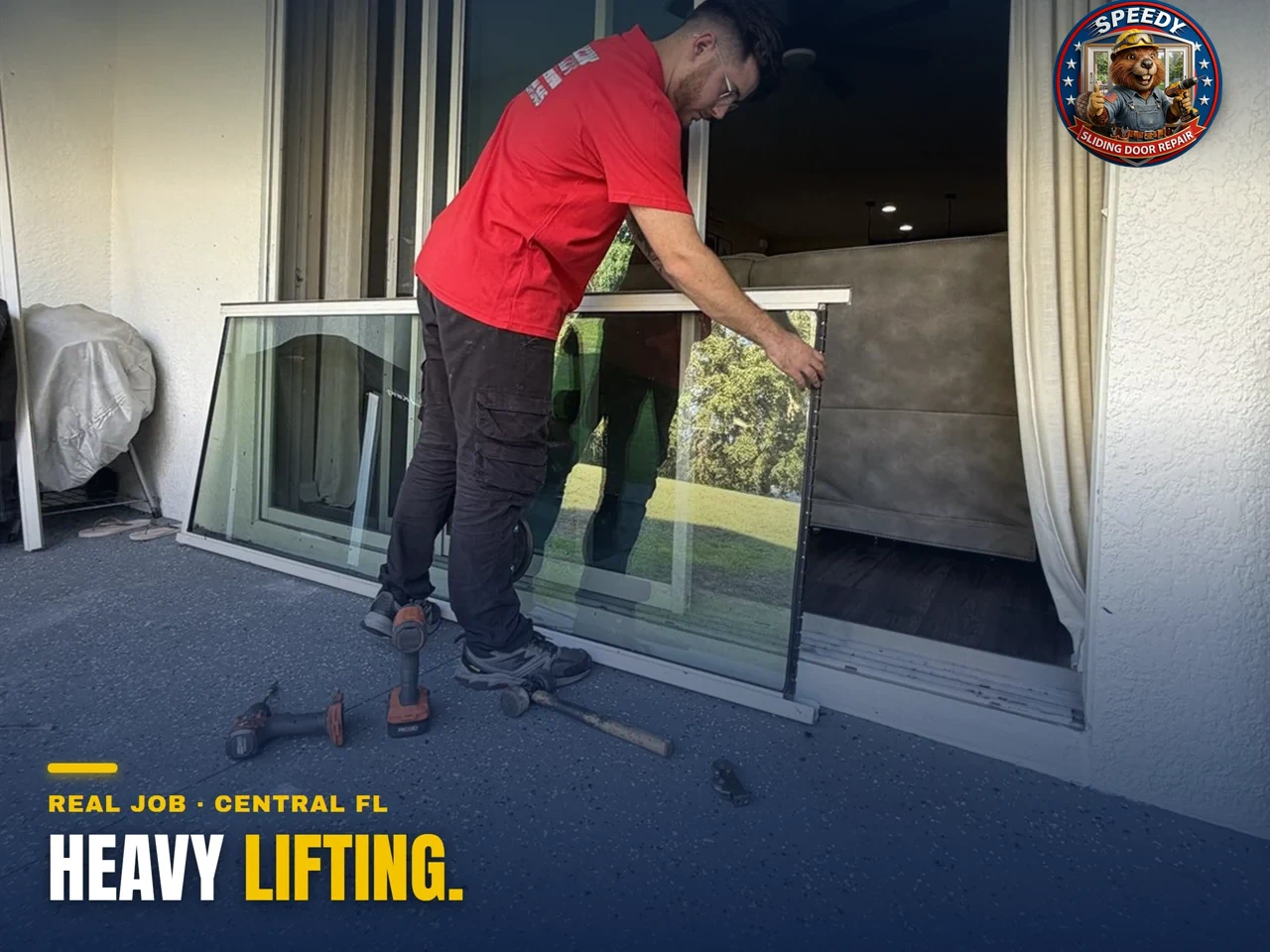 Speedy technician carefully carrying a heavy sliding glass door panel during a repair in Central Florida
