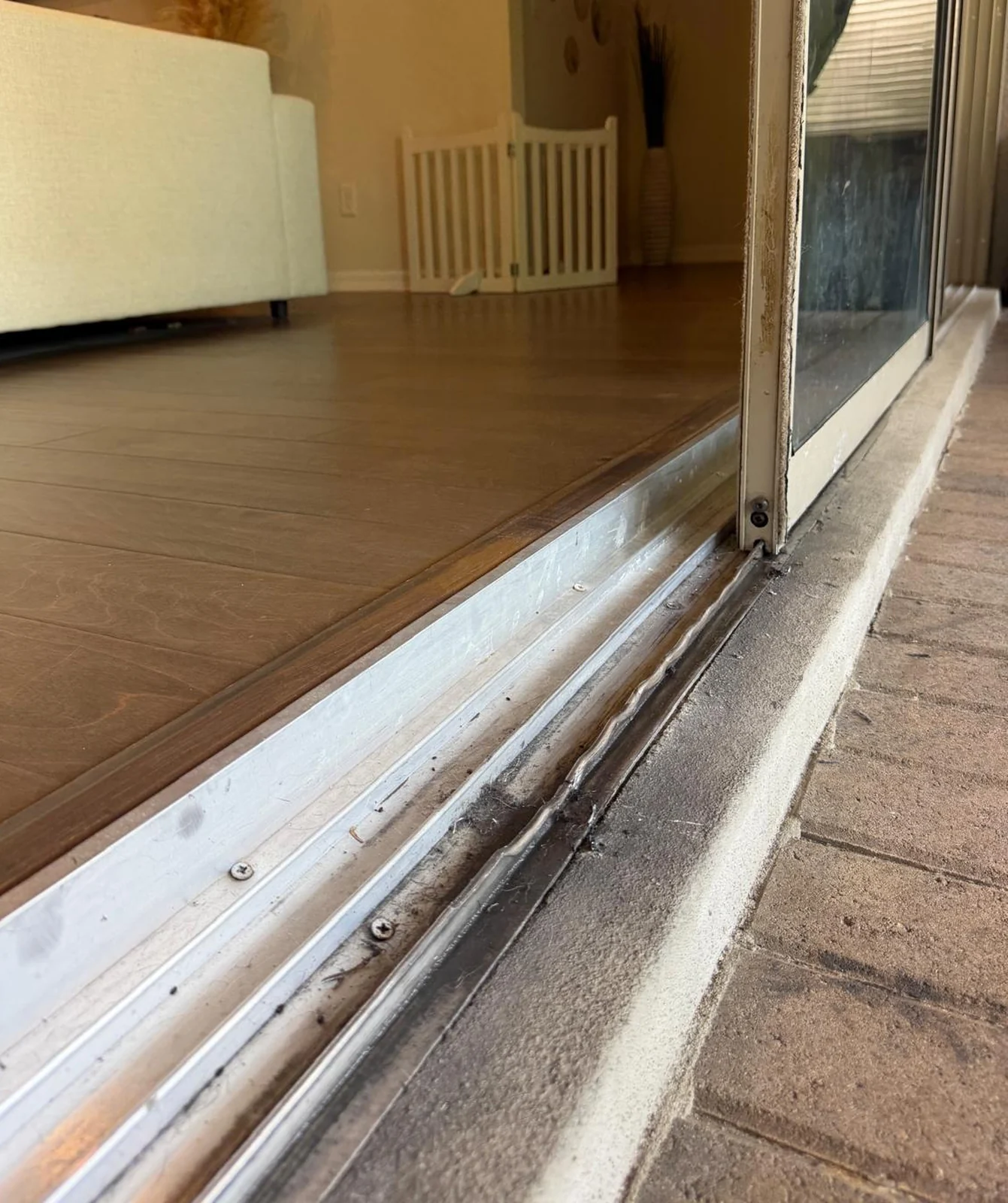 New stainless steel sliding door track installed to resist Central Florida salt corrosion
